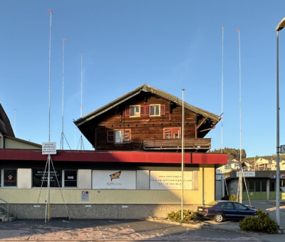 Holzchalet-Gebaeude neben anderen Haeusern, strassenlaterne im Vordergrund